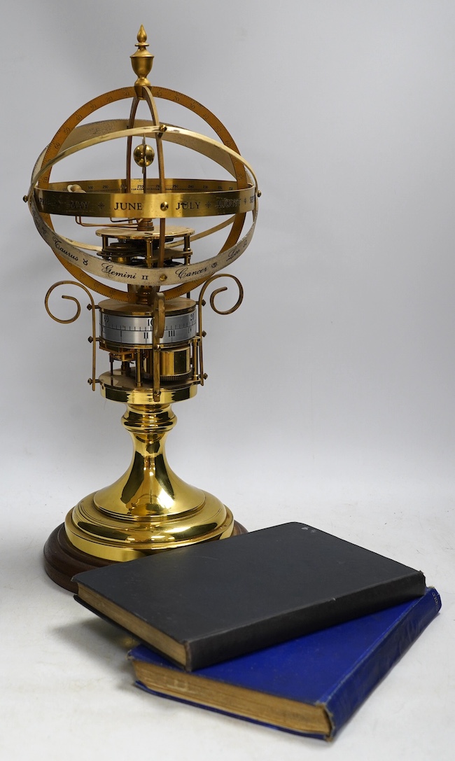 A modern clockwork armillary sphere, engraved St. James’s House Co. London, 44cm high, with two related books. Condition - fair, some discolouration to the metal work and general wear.